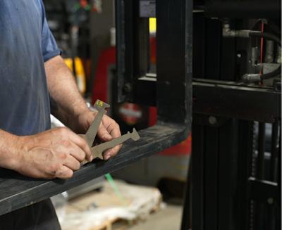 Technician holding Calipers on Forks