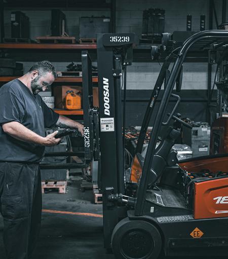 Technician working on a Doosan Forklift