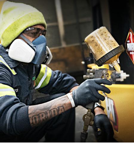 Technician painting a CAT® Forklift